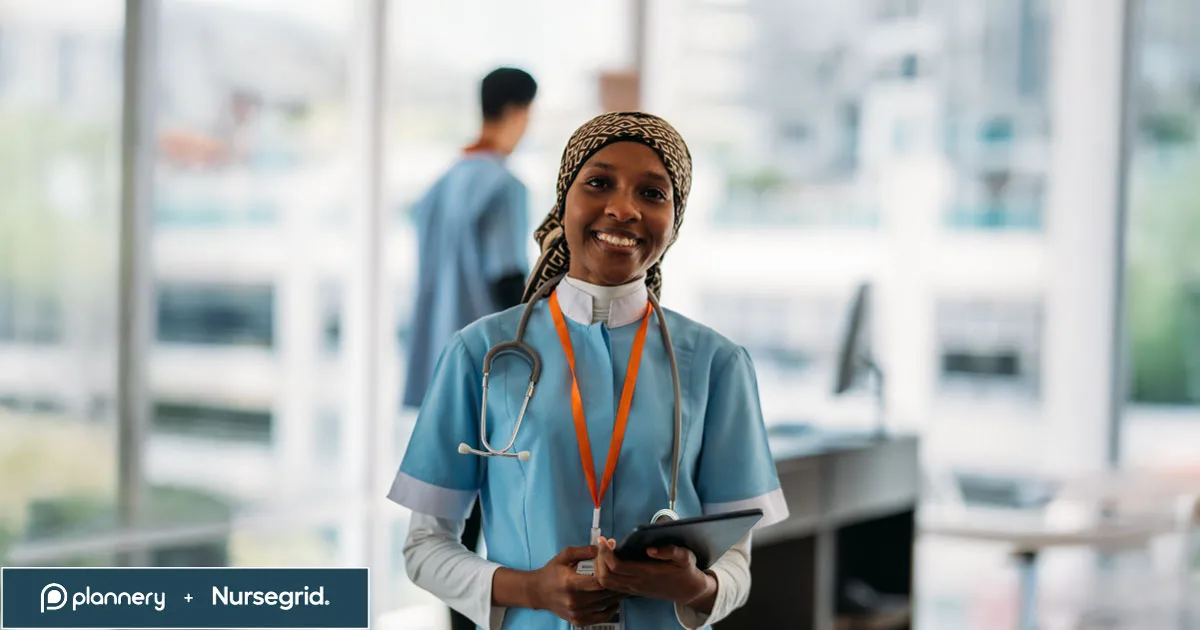 Smiling nurse wearing scrubs and a stethoscope holds a tablet in a bright hospital room; another medical professional is blurred in the background. Plannerly and Nursegrid logos are in the corner.
