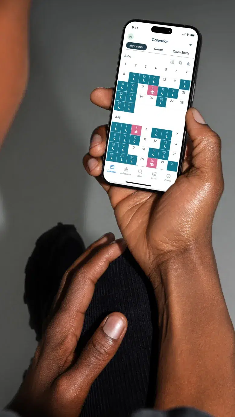A person holds a smartphone displaying a calendar app, showing scheduled events for June and July.