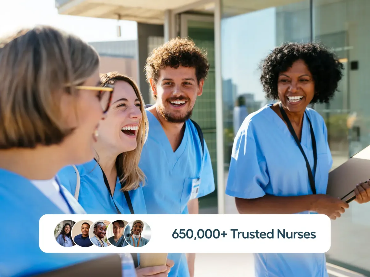 Four smiling nurses in scrubs walk outdoors; overlay text reads “650,000+ Trusted Nurses” backed by our staff scheduling software for nurses, with small profile images below.